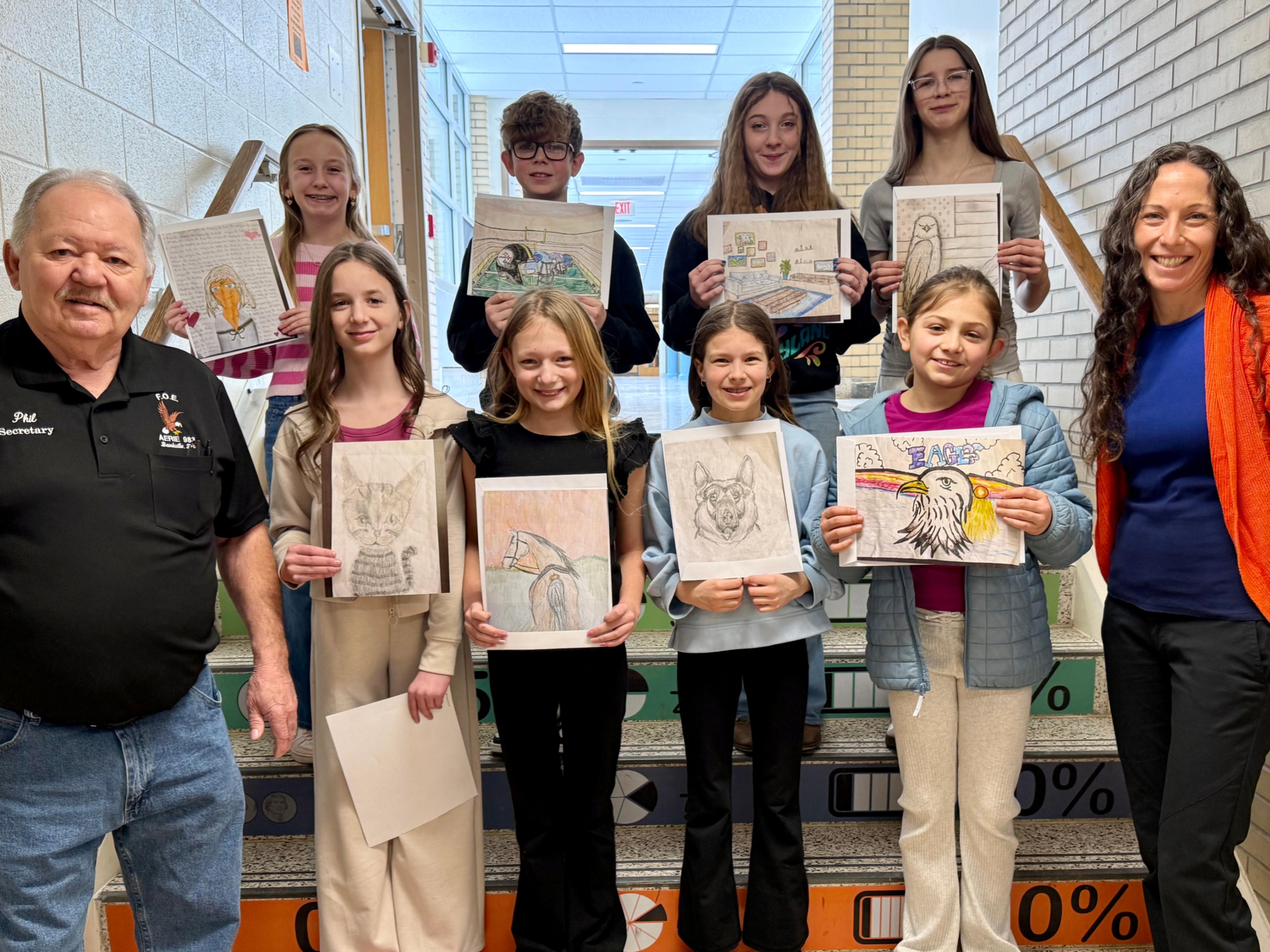 Hickory Grove students that placed in the Fraternal Order of Eagles art contest pose for a photo with FOE secretary Phillip Cook and art teacher Michelle Kimmerle.